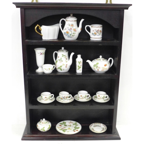 726 - A miniature Wedgwood tea set, etc., and a display case