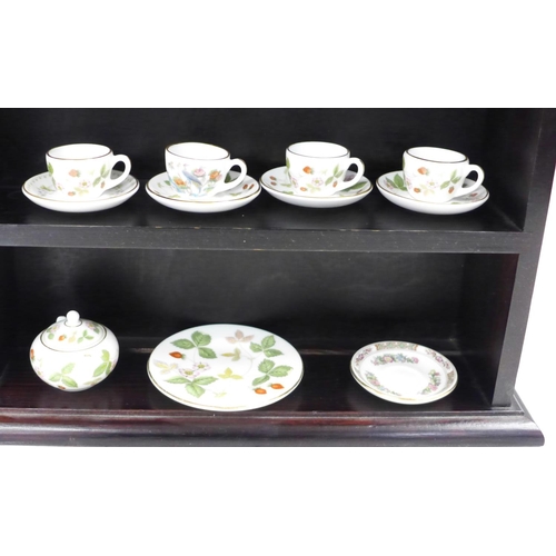 726 - A miniature Wedgwood tea set, etc., and a display case