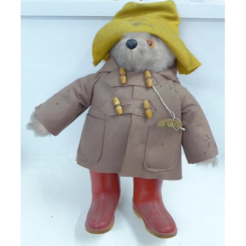 772 - A Gabrielle Designs Paddington Bear figure with red Dunlop Wellington boots, clothing with moth dama... 