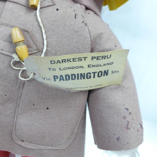 772 - A Gabrielle Designs Paddington Bear figure with red Dunlop Wellington boots, clothing with moth dama... 