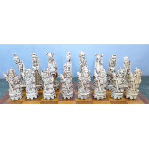 800 - A resin chess set with Chinese figures and wooden board (complete)