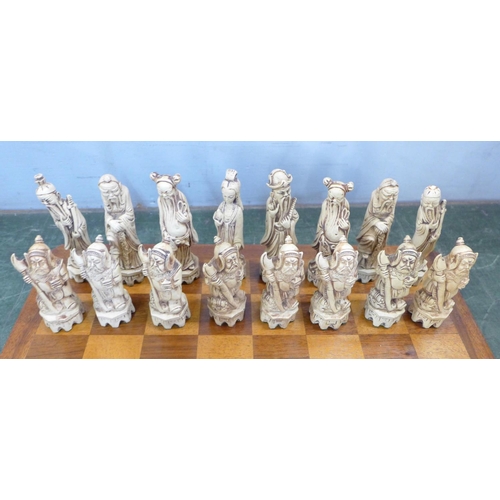 800 - A resin chess set with Chinese figures and wooden board (complete)