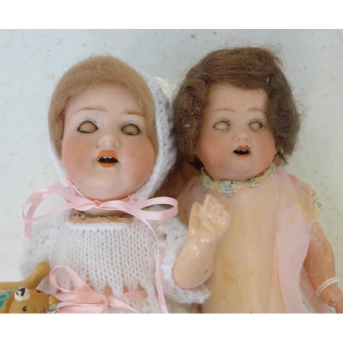 810 - Two dolls; a German Heubach bisque head doll with pale blue sleep eyes, 500 14/0 identification mark... 