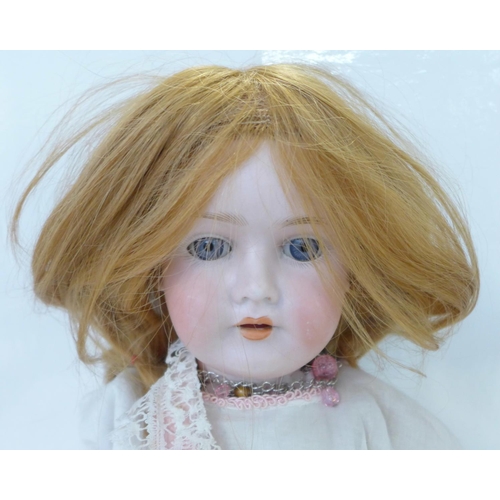 814 - A German C M Bergman bisque head doll with blue open eyes, 1916-8 identification mark, circa 1916, 5... 