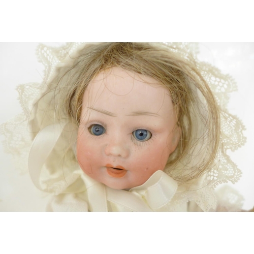 821 - A German PM bisque head doll with blue sleep eyes, 914 2/0 identification mark, circa 1920's, 27cm