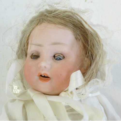 821 - A German PM bisque head doll with blue sleep eyes, 914 2/0 identification mark, circa 1920's, 27cm