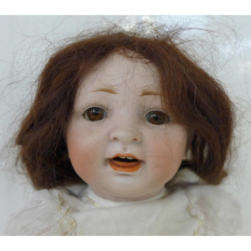 822 - A German Hertel Schwab bisque head doll with brown sleep eyes, 152-2 identification marks, circa 191... 