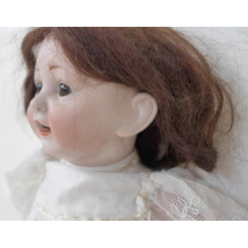 822 - A German Hertel Schwab bisque head doll with brown sleep eyes, 152-2 identification marks, circa 191... 