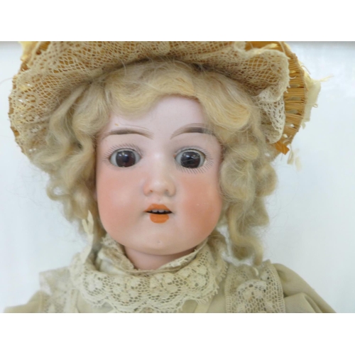 827 - A German Armand Marseille bisque head doll with brown sleep eyes AO½M identification mark, circa 191... 