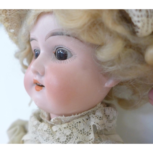 827 - A German Armand Marseille bisque head doll with brown sleep eyes AO½M identification mark, circa 191... 