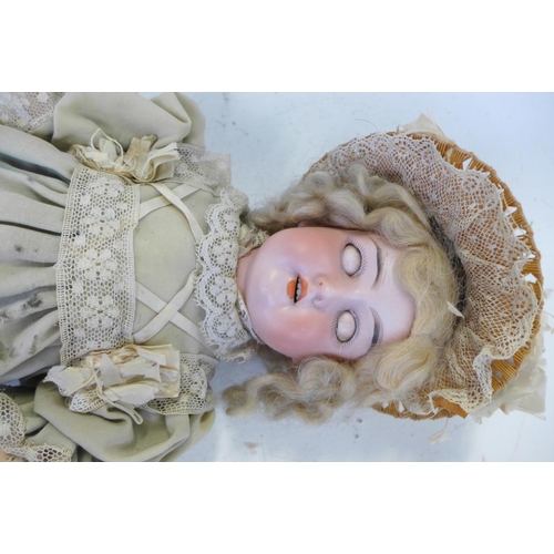 827 - A German Armand Marseille bisque head doll with brown sleep eyes AO½M identification mark, circa 191... 