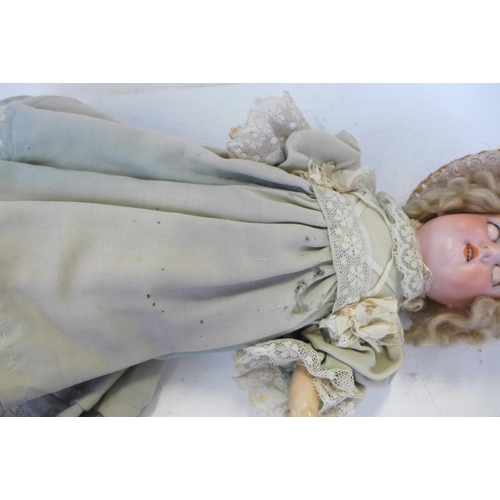 827 - A German Armand Marseille bisque head doll with brown sleep eyes AO½M identification mark, circa 191... 