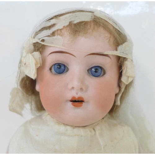 828 - A German Cuno Otto Dressel bisque head doll with blue sleep eyes, 8/0 identification mark, circa 191... 