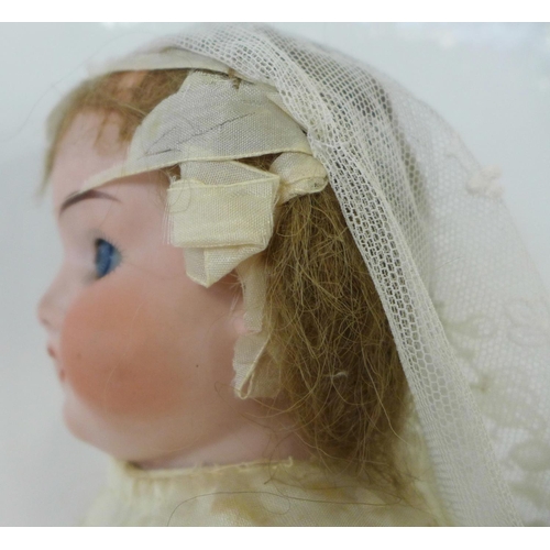 828 - A German Cuno Otto Dressel bisque head doll with blue sleep eyes, 8/0 identification mark, circa 191... 