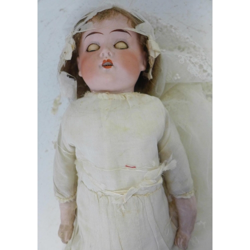 828 - A German Cuno Otto Dressel bisque head doll with blue sleep eyes, 8/0 identification mark, circa 191... 