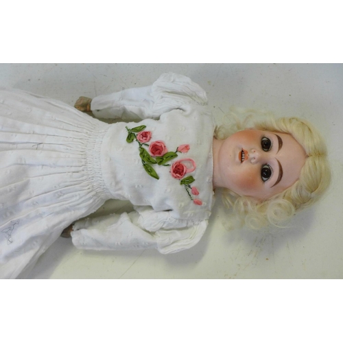 829 - A German Ernst Heubach bisque head doll with brown open eyes, 902-4/0 identification mark, circa 190... 