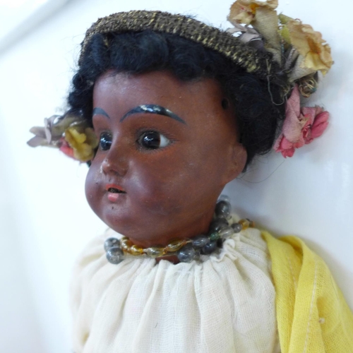 830 - A German bisque head doll with brown open eyes, 1321 identification mark and a brown painted bisque ... 