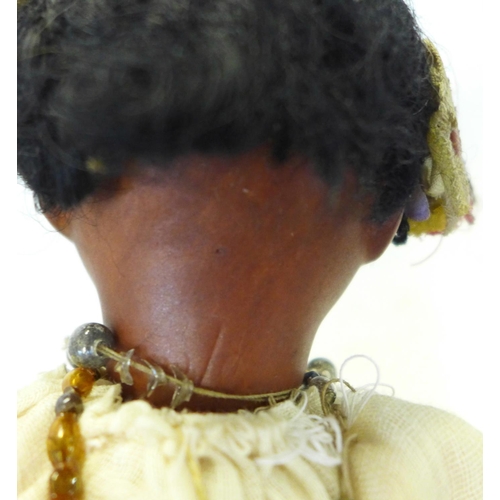 830 - A German bisque head doll with brown open eyes, 1321 identification mark and a brown painted bisque ... 