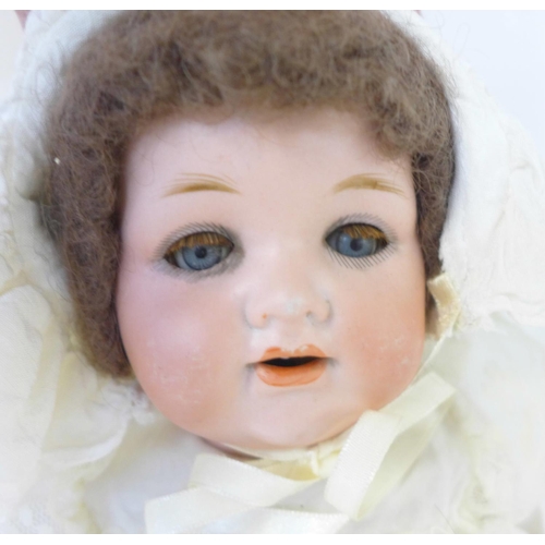 832 - A German Armand Marseille bisque head doll with blue sleep eyes, 990 O ½ M identification mark, circ... 