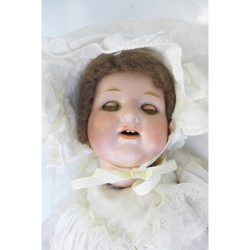 832 - A German Armand Marseille bisque head doll with blue sleep eyes, 990 O ½ M identification mark, circ... 