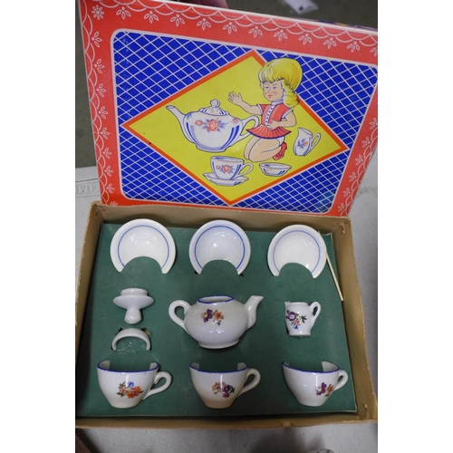 833 - A boxed Royal Doulton collectors doll, an Alberon doll, three dolls tea sets and two small wooden ar... 