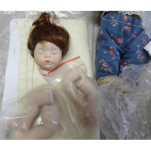 835 - A small box of mixed bisque and composition doll body parts including a German E&S head