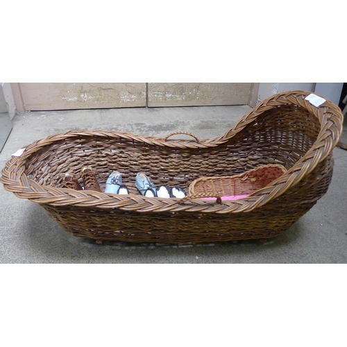 841 - A baby's wicker crib, a toy wicker crib and four pairs of baby's shoes