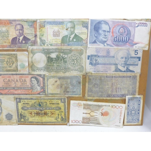 860 - A collection of mounted banknotes, mainly foreign, a Peppiatt £1 note and an O'Brien ten shillings n... 