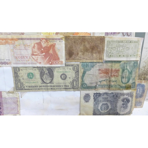 860 - A collection of mounted banknotes, mainly foreign, a Peppiatt £1 note and an O'Brien ten shillings n... 