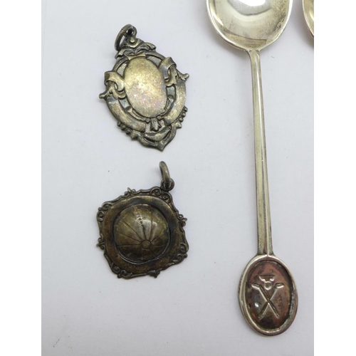 901 - Four silver spoons and two silver fobs including one football, 51g