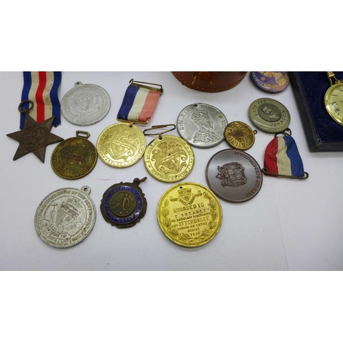 915 - A collection of medals and badges, a stick pin and a fob watch