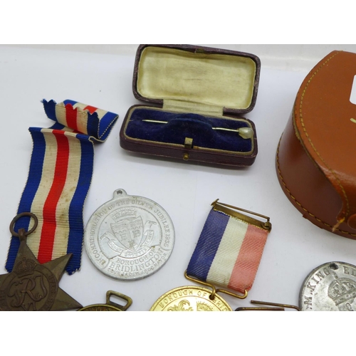 915 - A collection of medals and badges, a stick pin and a fob watch