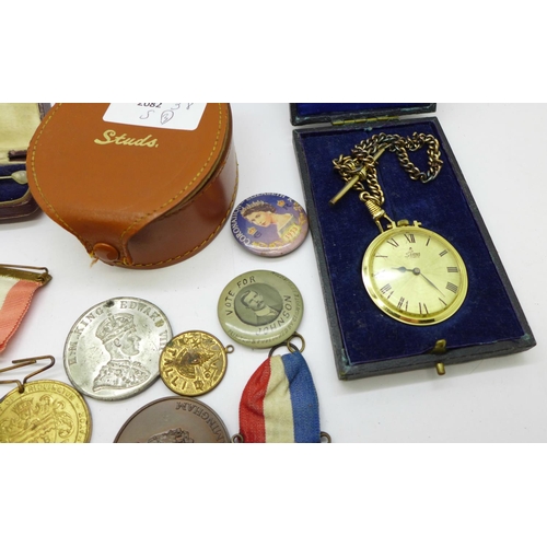 915 - A collection of medals and badges, a stick pin and a fob watch