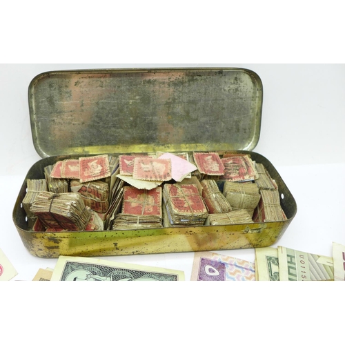 920 - A tin with a large collection of penny red stamps, several hundred, and a collection of banknotes