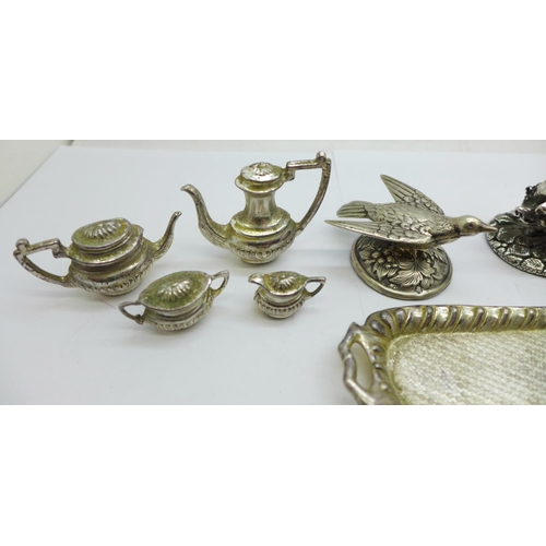 922 - A silver covered pig, a/f, a bird, two pots and a miniature doll's house tea service