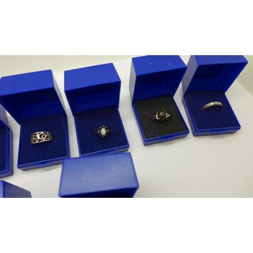 939 - Eleven silver rings including one opal and sapphire cluster, boxed