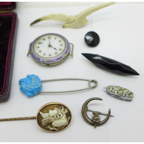 981 - Two stick pins, an enamelled wristwatch head, a/f, two brooches, etc.