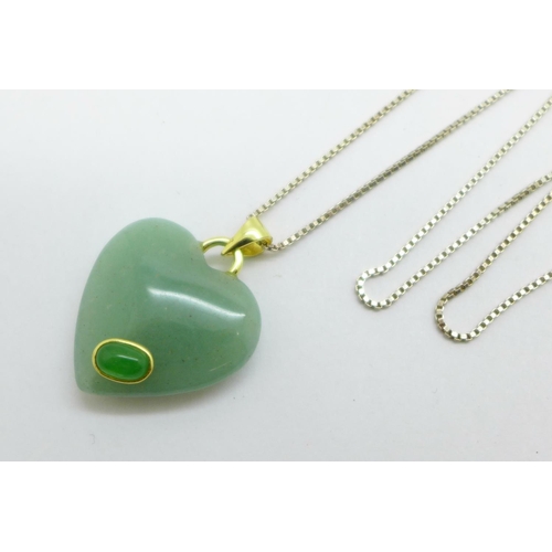 987 - A silver gilt mounted heart shaped pendant on a silver chain, heart 23mm wide