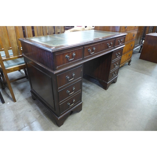 104 - A mahogany and green leather topped pedestal desk