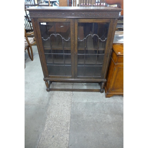 111 - A carved oak two door bookcase