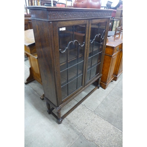 111 - A carved oak two door bookcase