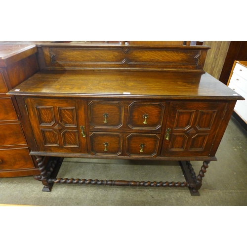 119 - An oak geometric moulded barleytwist sideboard