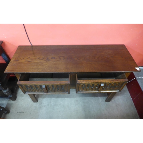 12 - A 17th Century style carved oak two drawer dresser