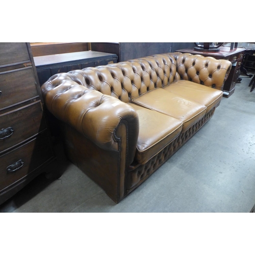 131 - A tan leather Chesterfield settee, a/f