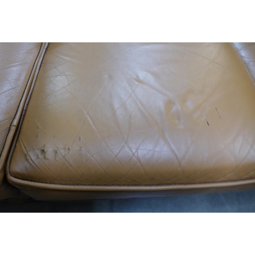 131 - A tan leather Chesterfield settee, a/f