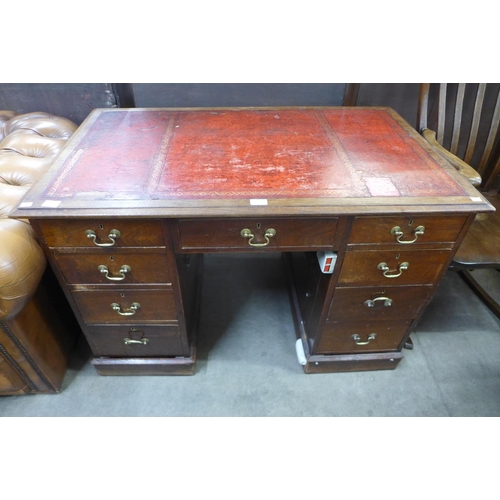 132 - A Victorian oak and red leather topped desk