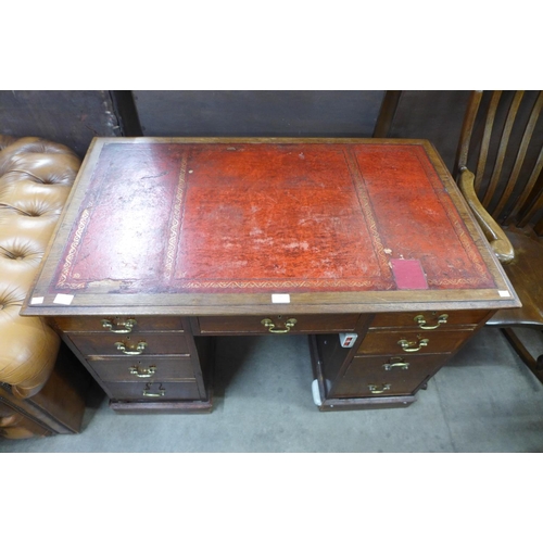 132 - A Victorian oak and red leather topped desk