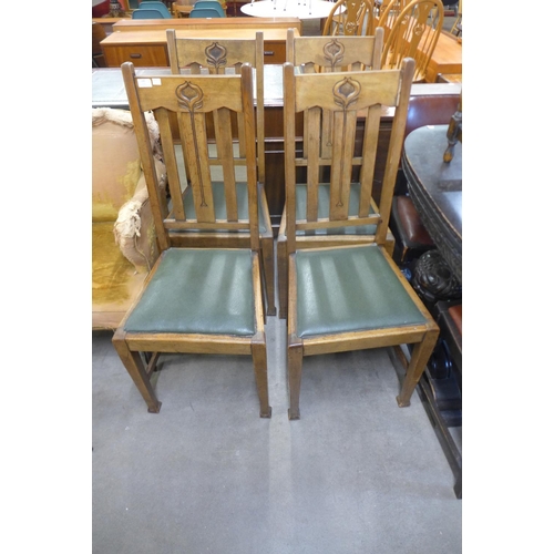 145 - A set of four Arts and Crafts oak chairs