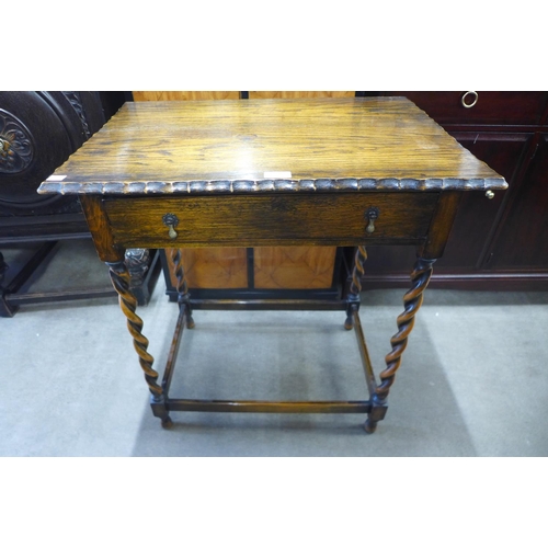 146 - A carved oak barleytwist single drawer side table