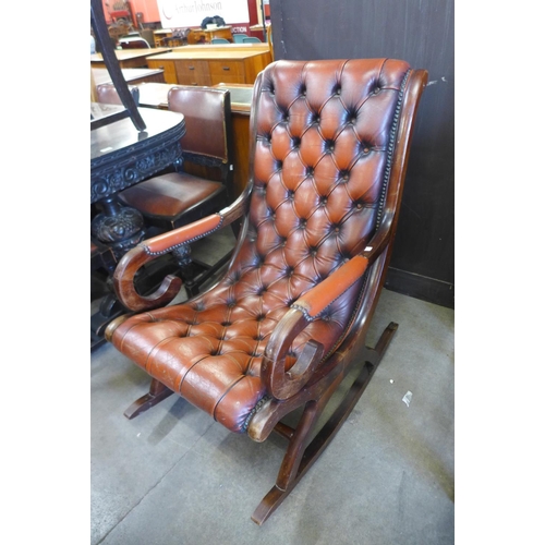 147 - A mahogany and red leather rocking chair